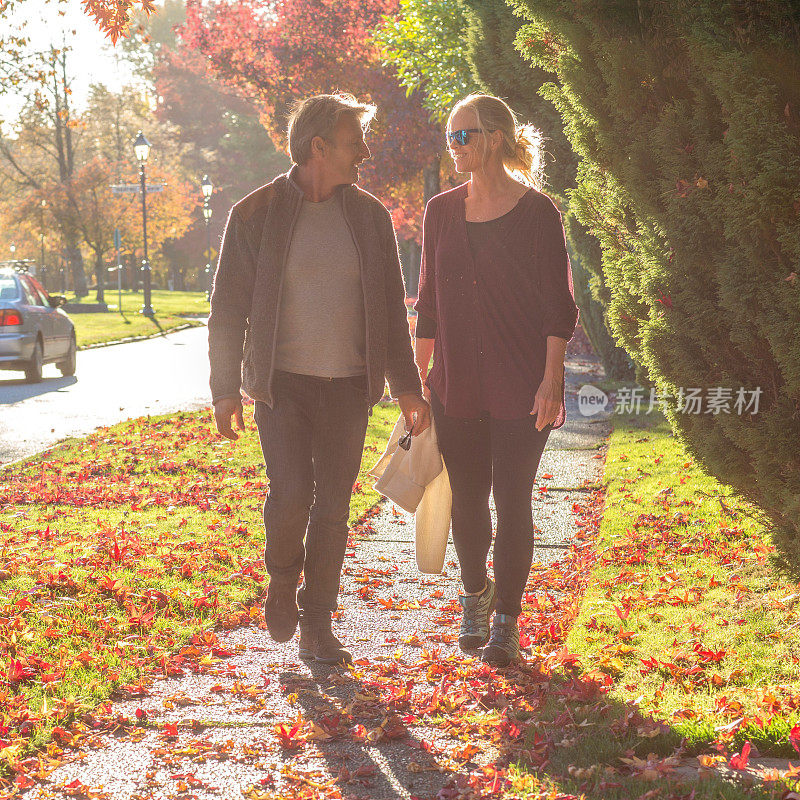 清晨，一对成熟的夫妇漫步在秋日的街坊之间
