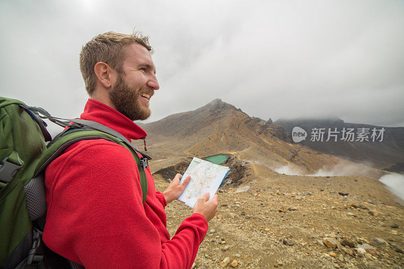 一个登山者在山上看地图