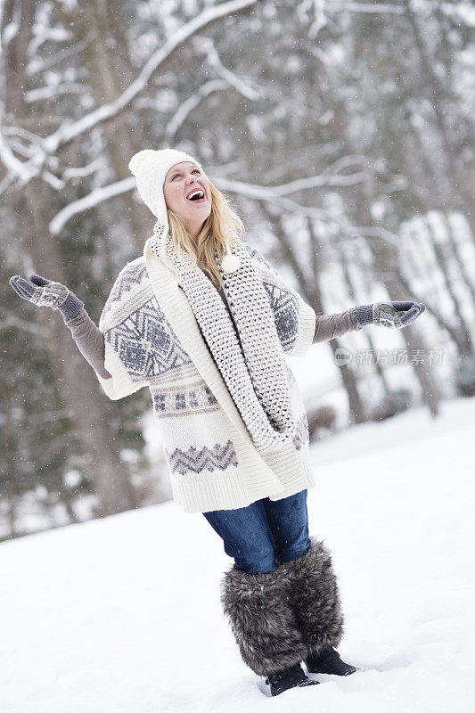 微笑的女人接着飘落的雪花