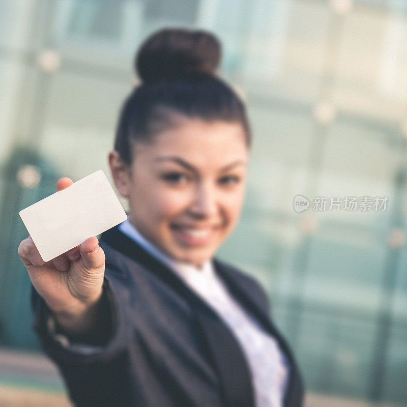 年轻的主管微笑着拿着一张白色的信用卡
