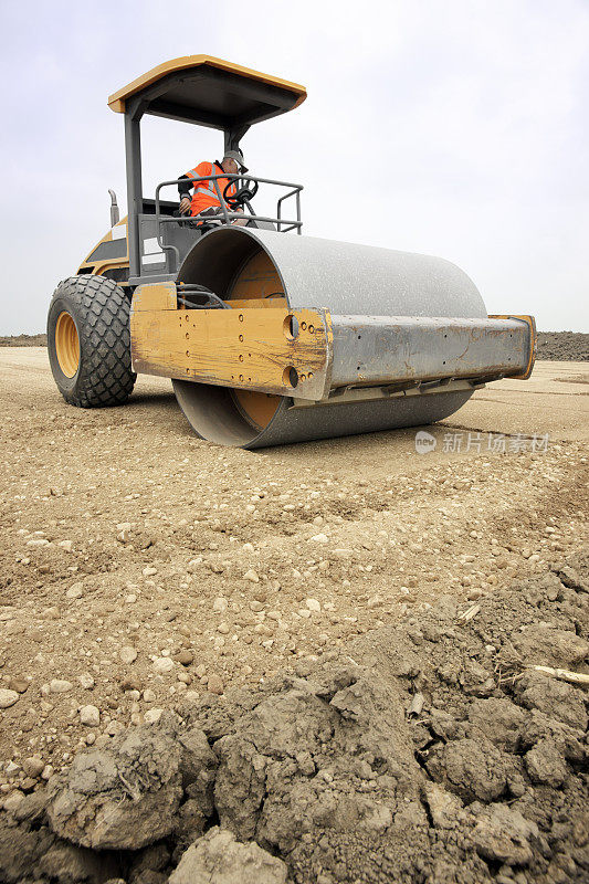 正在建设的公路用压路机压实地下路面