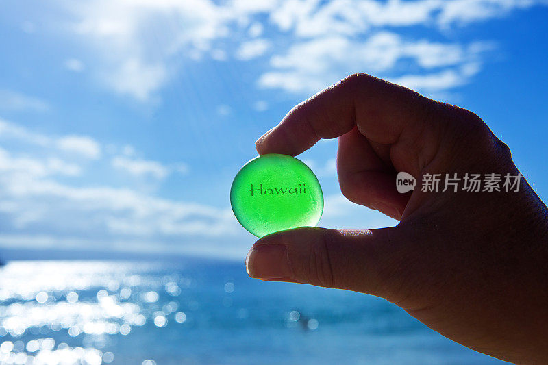 手拿海玻璃，写着“夏威夷”