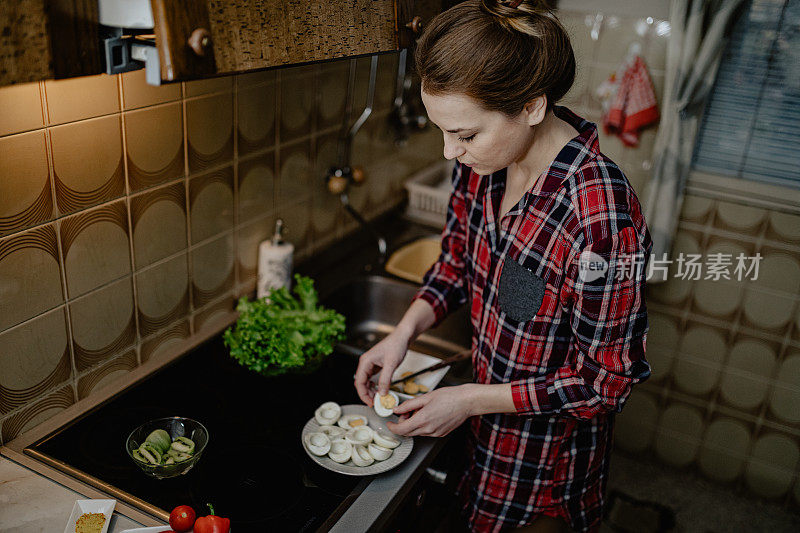 穿着休闲的女人在厨房剥鸡蛋