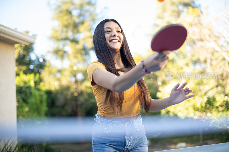 年轻女子在后院打乒乓球