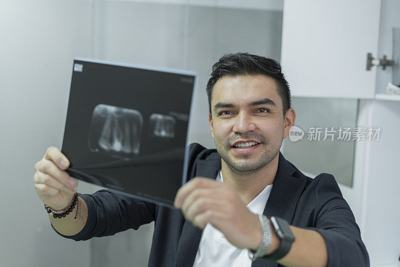 肖像牙科医生检查病人的牙齿的x光之前，进入干预程序