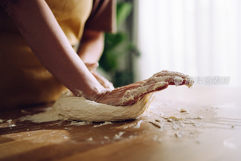 匿名妇女用手揉面团做自制面包