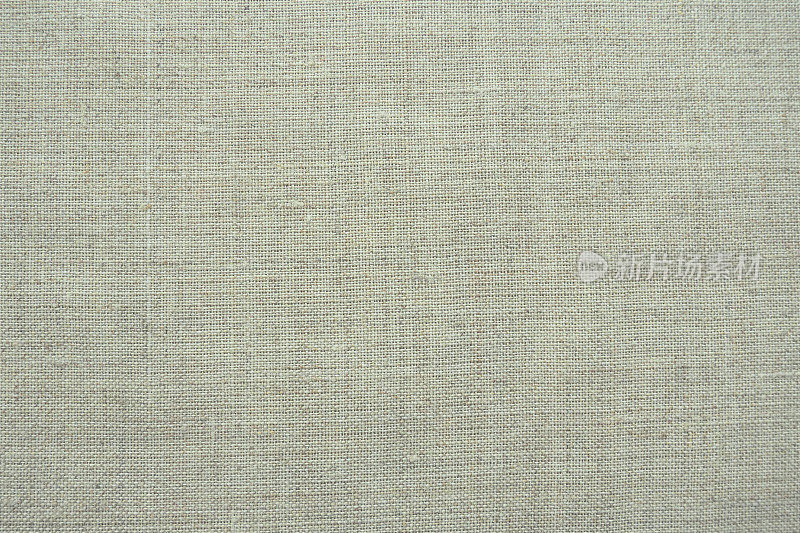 织物纹理背景。浅灰色带织织物。材料自然的微皱外观。统一复制空间背景。均匀地铺在表面的棉、帆布或羊毛薄织物。