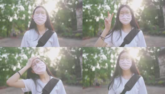 亚洲少女在口罩后微笑的肖像在新冠肺炎疫情高清在线视频素材下载