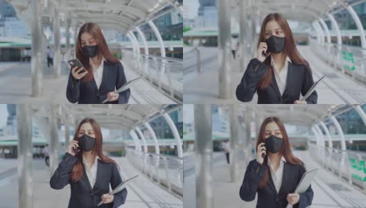 年轻的女商人在办公室外工作时要戴上防护口罩高清在线视频素材下载