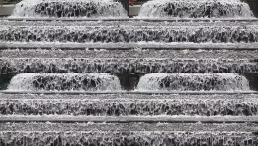 喷泉瀑布特写，水从不同的高度下降。高清在线视频素材下载