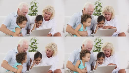 爷爷奶奶和孙子们一起使用平板电脑高清在线视频素材下载