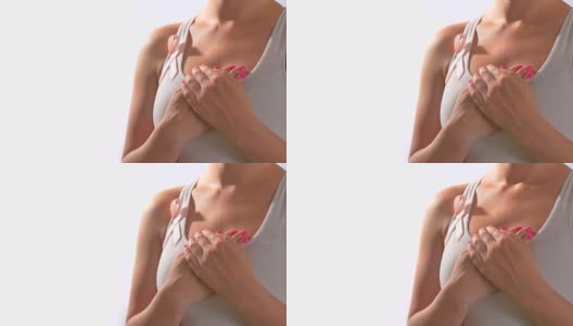 粉红丝带乳腺癌，年轻女子双手紧握胸口，呼吸缓慢高清在线视频素材下载