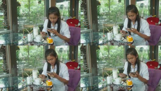 亚洲少女在咖啡店用手机高清在线视频素材下载
