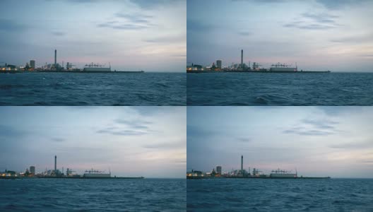 黄昏时分，瑞典赫尔辛堡的工业港。多风的天气，海浪高清在线视频素材下载