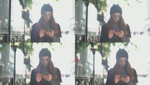 年轻女子在街上使用手机高清在线视频素材下载