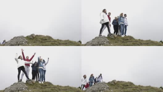 快乐的一群朋友爬上山顶，跳跃，举起手臂，享受他们的成就的成功高清在线视频素材下载