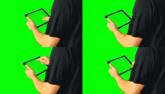 男人使用绿色屏幕的平板电脑在大屏幕上翻倍。高清在线视频素材下载