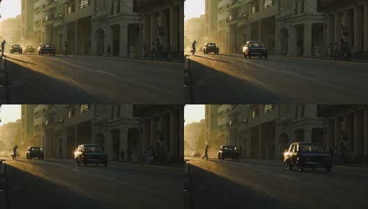 哈瓦那夕阳下的行人和老爷车高清在线视频素材下载