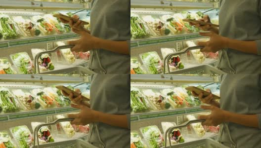 在超市用智能手机的女人高清在线视频素材下载
