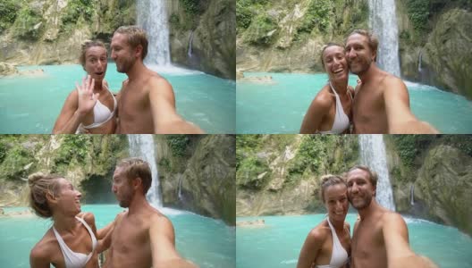 年轻夫妇与美丽的瀑布自拍高清在线视频素材下载