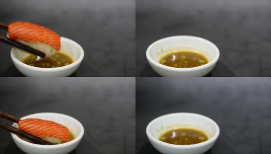 手拿寿司用木筷子蘸芥末和日式酱油高清在线视频素材下载