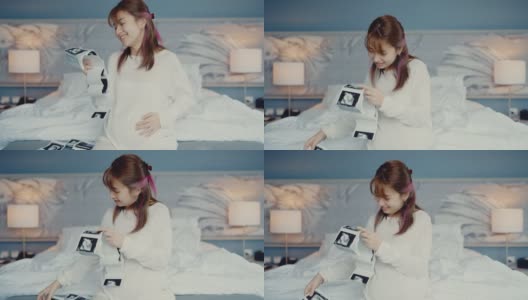 孕妇看3D超声扫描照片。高清在线视频素材下载