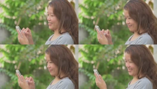 亚洲女人玩手机用手写笔高清在线视频素材下载