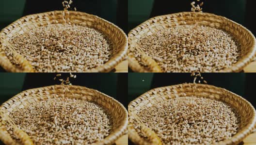 SLO MO小麦种子落入柳条碗高清在线视频素材下载