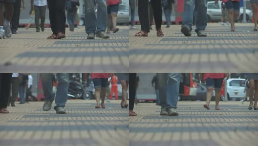 步行或通勤上班的人群。低角度拍摄的脚和腿行走在非常炎热的夏天高清在线视频素材下载