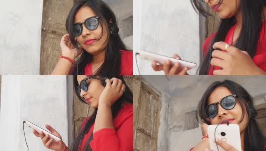 印度拉贾斯坦邦一名年轻女子手持手机微笑，用手机发短信打电话高清在线视频素材下载