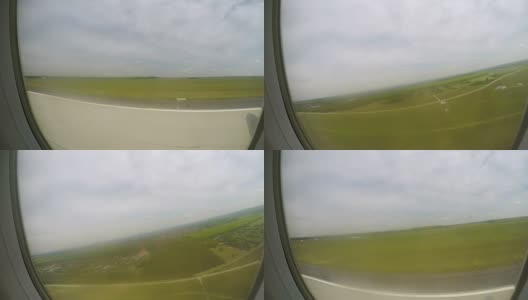 飞机从跑道上起飞，在空中不断上升，窗外有绿色景观高清在线视频素材下载