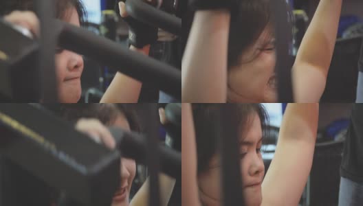 亚洲女性健美运动员在健身房里的运动器械上进行运动训练。高清在线视频素材下载