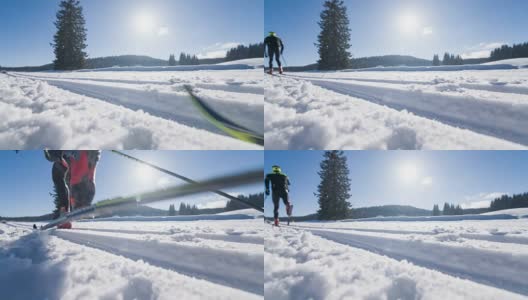 在一条平行的槽状滑雪跑道上的越野滑雪者高清在线视频素材下载