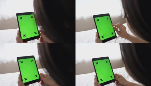 一个女人的手握绿色屏幕平板电脑的特写高清在线视频素材下载