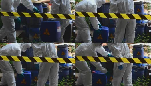 两位亚洲科学家通过鉴定危险的化学物质而穿上防护服高清在线视频素材下载