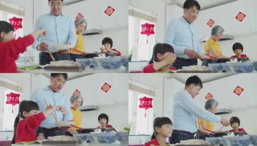 兴奋的小女孩帮助爸爸和奶奶做火锅高清在线视频素材下载