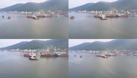 Flycam放大了在港口起重机的帮助下驶过码头的船只高清在线视频素材下载
