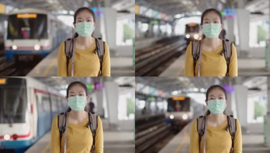 亚洲女性游客戴着口罩在站台上等候火车。高清在线视频素材下载