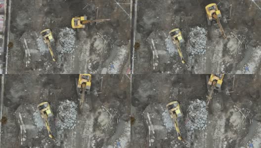 地面上建筑工地的工人和挖掘机的无人机鸟瞰图高清在线视频素材下载