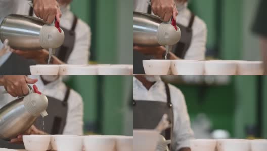 近距离观看专业亚洲华人咖啡师将热水倒入陶瓷咖啡杯中准备拔杯咖啡品质测试高清在线视频素材下载