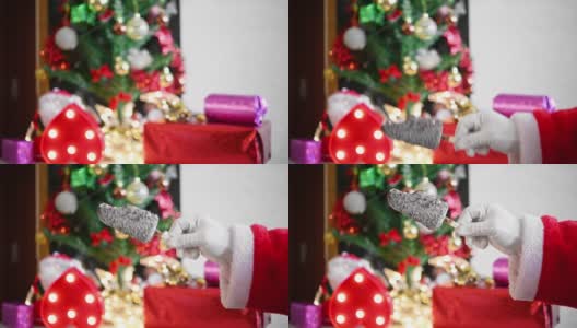 圣诞老人在家里的圣诞装饰前举起一根巧克力冰棒咬一口高清在线视频素材下载