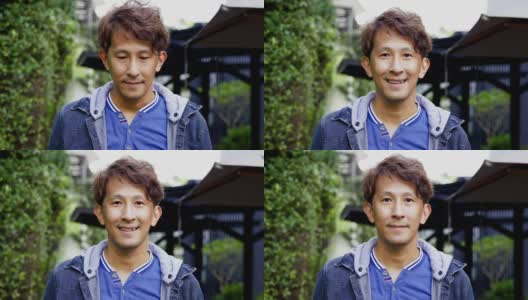 脸部特写迷人的亚洲男子短发自信的微笑充满积极的热情。快乐来自健康。看相机。积极思考的概念高清在线视频素材下载