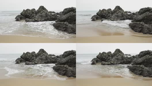 海浪拍打着海滩和岩石礁高清在线视频素材下载