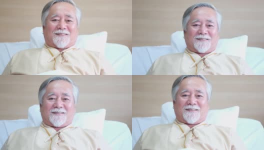 亚洲老年患者躺在康复室的床上，看起来轻松愉快，治疗后病情有所好转。老年人退休后医疗保障的概念、医学、人、医院。高清在线视频素材下载