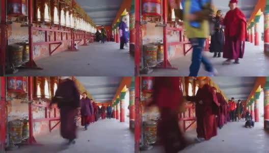 喇嘛和尼姑在拉容伽(拉容五科佛学院)的转经轮上散步。这是中国四川色达著名的喇嘛庙。高清在线视频素材下载