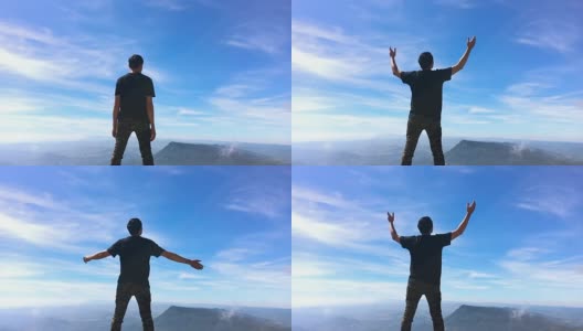 一个人站在山上，手臂举得很慢。蓝天和白云高清在线视频素材下载