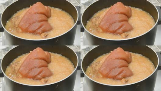宽角度的红烧猪腿与汤在煮锅中放大闭合高清在线视频素材下载