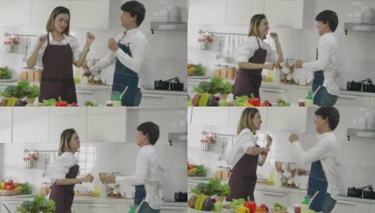 亚洲夫妇在厨房一起跳舞;慢动作高清在线视频素材下载