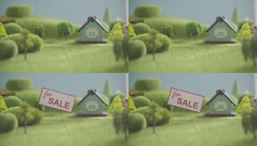 房子出售的标志。玩具屋在有树的田野里高清在线视频素材下载