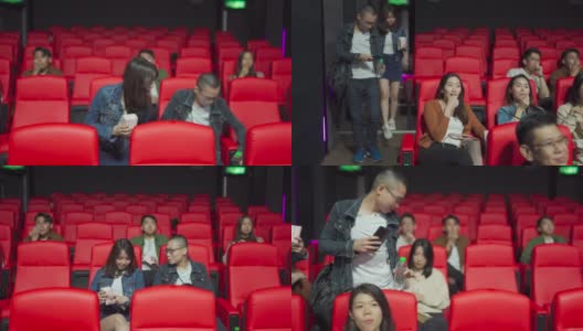 在电影放映时间，一对亚洲中国夫妇进入电影院，试图穿过其他观众到达他们的座位高清在线视频素材下载